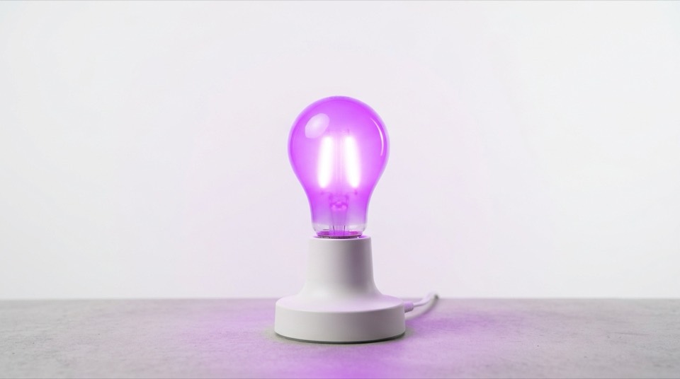 Smart light bulb glowing purple — Smart Lighting
